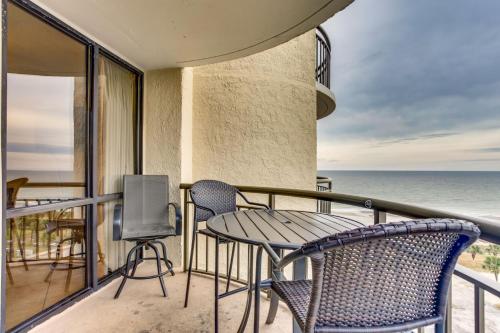 a balcony with a table and chairs and the ocean at Spectacular Oceanview Condos in Myrtle Beach