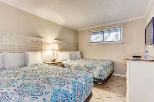 a hotel room with two beds and a window at Spectacular Oceanview Condos in Myrtle Beach