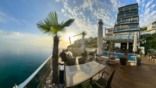 a balcony of a hotel with a view of the water at Apart Lux Beciragic in Dobra Voda
