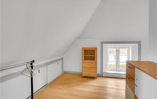 an attic kitchen with white walls and wooden floors at Amazing Home In Haderslev With Kitchen in Haderslev