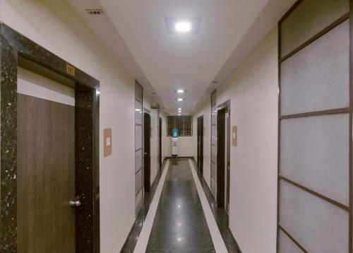 a corridor of a hospital hallway with doors at Prasana Residency in Tiruchchirāppalli
