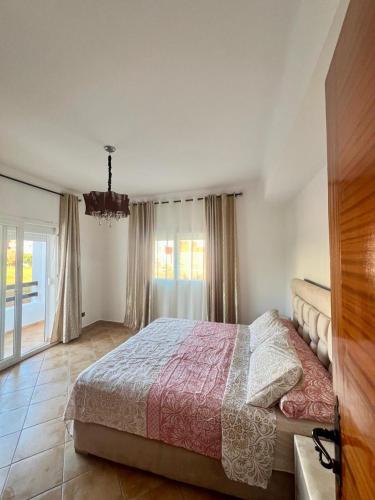 a bedroom with a bed and a large window at Relax Island in Oued Laou