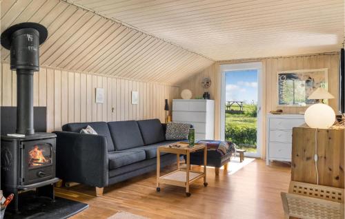 a living room with a couch and a stove at 2 Bedroom Amazing Home In Bogø By in Bogø By