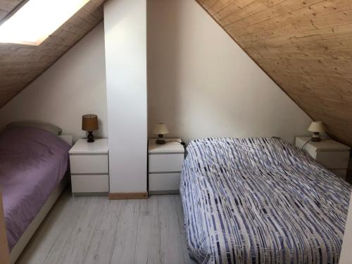a bedroom with a bed and two night stands at Au Cœur des montagnes in La Chalp