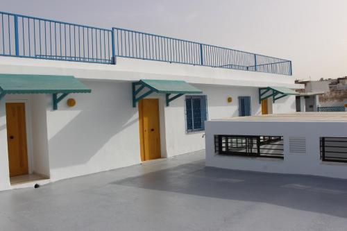 a white building with a staircase on top of it at Hôtel Medina in Sousse
