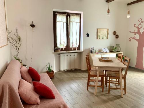 a living room with a couch and a table at La casa Rosa in Piobesi dʼAlba