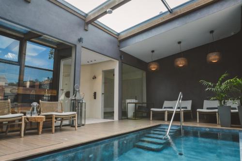 a house with a swimming pool and a patio at Frost Boutique Hotel in Pärnu