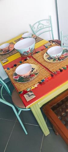 a table with plates and bowls on top of it at Riad SULTANA lateral seaview in Saidia 
