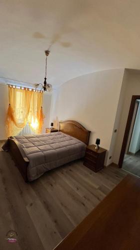 a bedroom with a large bed and a window at Spada Reale in Valdieri