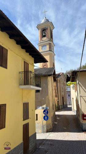 a building with a clock tower in a town at Spada Reale in Valdieri