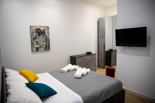 a bedroom with a bed with towels on it at Filo Apartment in Capua
