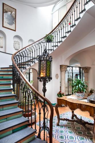 an ornate staircase in a home with a stair case at Hotel Residence in Amalfi