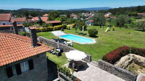 an external view of a villa with a swimming pool at Casa do Souto in Aldreu