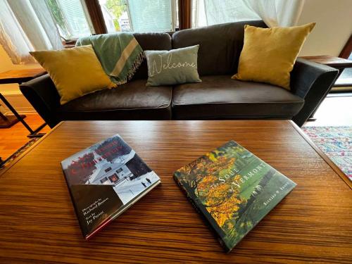 two books on a coffee table in front of a couch at Air Vermont Apartment in South Burlington