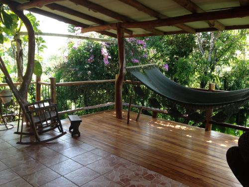 a hammock on a deck with a hammock at Villa Mango B&B in Nosara