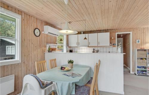 a kitchen and dining room with a table and chairs at 3 Bedroom Awesome Home In Saltum in Saltum