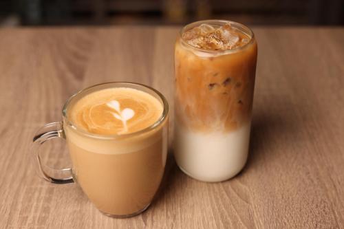 two cups of coffee sitting on a wooden table at Smart Brickell Hotel in Miami