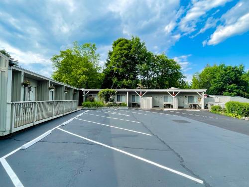 an empty parking lot in front of a building at Waters Edge Lodge in Lake George
