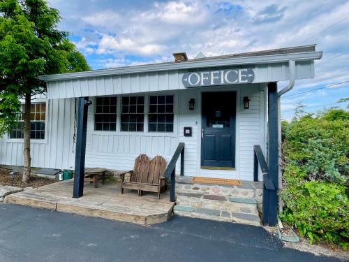 an office building with a bench in front of it at Waters Edge Lodge in Lake George