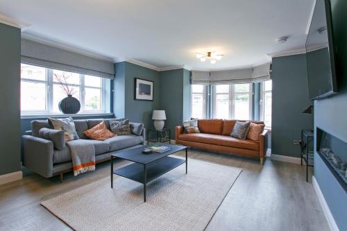 a living room with two couches and a table at Troon No 1 Apartments in Troon