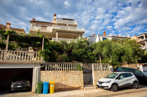 a white car parked in front of a building at La casa di Marko in Rabac