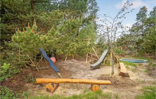 a playground with a slide and a swing set at Holiday Home Romo Lxx in Toftum