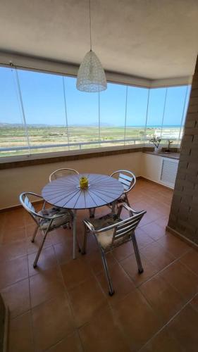a table and chairs in a room with a window at Apartamento Torre la Sal in Cabanes