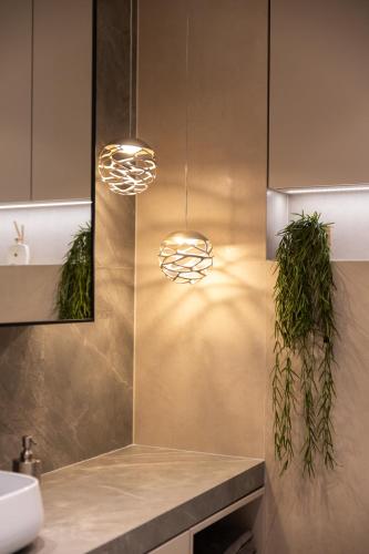 a bathroom with two pendant lights and a sink at Dream by the sea in Opatija