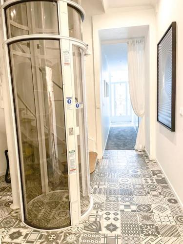 un couloir avec une douche en verre dans un bâtiment dans l'établissement Studio romantique - N6, à Aleçon