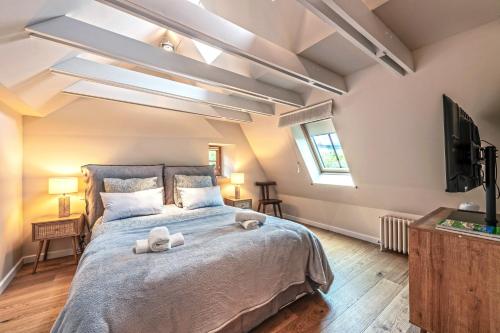 a bedroom with a large bed with two towels on it at Ar Barzh Kadiou III in Quimper
