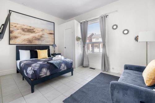 a bedroom with a bed and a couch at Stylish & Inviting Private Bedroom in Corso Italia in Toronto