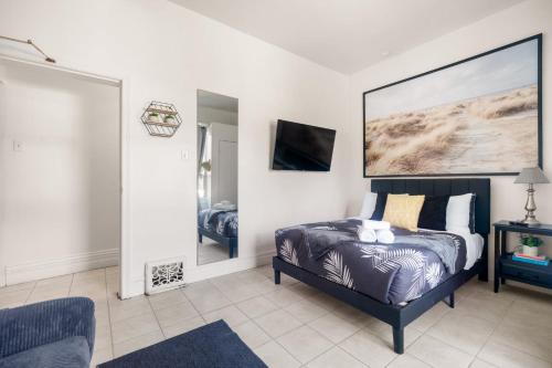 a bedroom with a bed and a large painting on the wall at Stylish & Inviting Private Bedroom in Corso Italia in Toronto