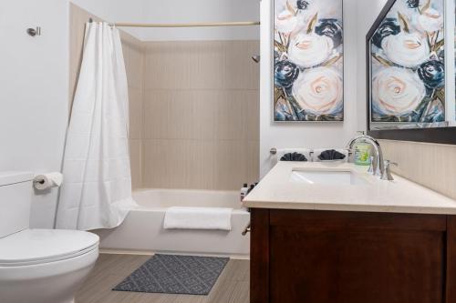 a bathroom with a sink and a toilet and a shower at Stylish & Inviting Private Bedroom in Corso Italia in Toronto