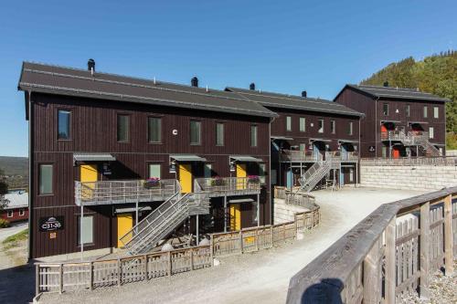 a brown building with stairs in front of it at Funäs Ski Lodge in Funäsdalen