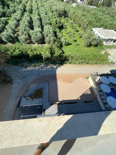 an overhead view of a house with a large shadow at Apartments NIKOS FAMILY in Ulcinj