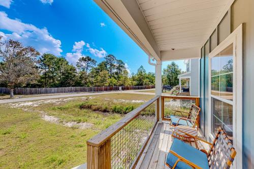 a porch with two benches and a view of a street at Lighthouse Cove in Carrabelle