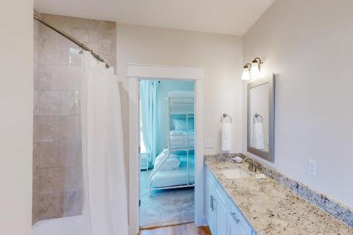 a white bathroom with a sink and a shower at Lighthouse Cove in Carrabelle