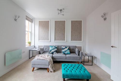 a living room with a couch and a table at Quiet Luxury 2 Bed Apartment with Patio in Central Leicester in Leicester