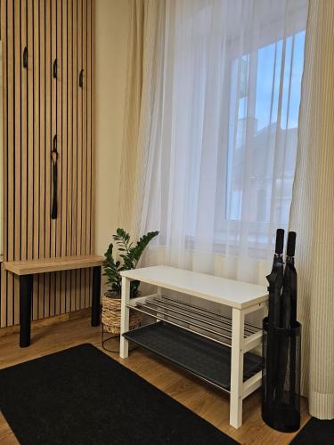 a white bench in a room with a window at ApartHotel Ritms in Krāslava