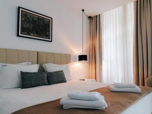 a bedroom with a bed with two towels on it at Coimbra Monumentais B&B in Coimbra