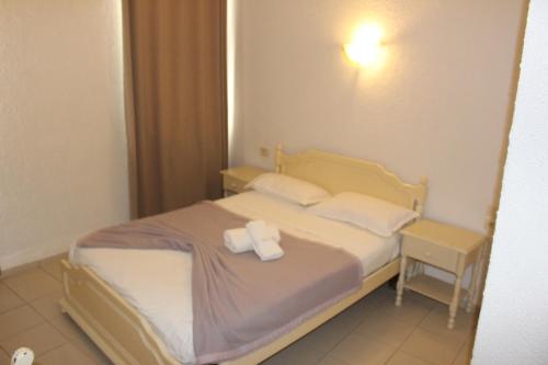 a bedroom with a bed with two towels on it at Hôtel Medina in Sousse