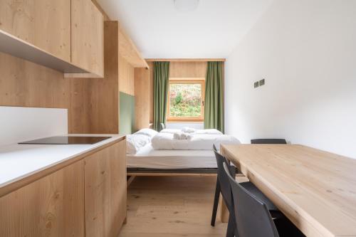 Postel nebo postele na pokoji v ubytování Ama Dolomiti - Residence
