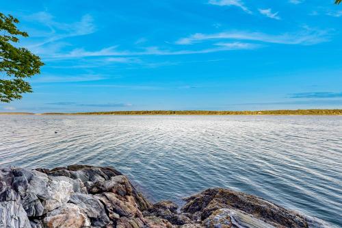 a view of a body of water with rocks at Muscongus Sound Lookout in Round Pond