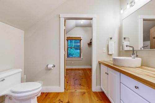 a bathroom with a white toilet and a sink at Muscongus Sound Lookout in Round Pond