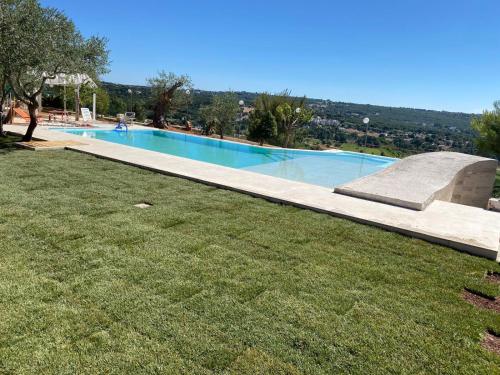 a swimming pool with a skateboard in the grass at oasi di pace fasano BIS in Fasano