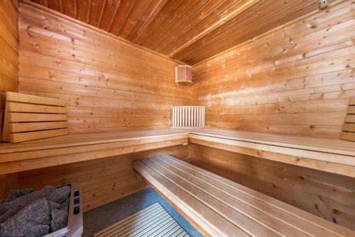 an empty wooden sauna with wooden walls and ceiling at Landhotel Zur Schmiede in Göhren-Lebbin