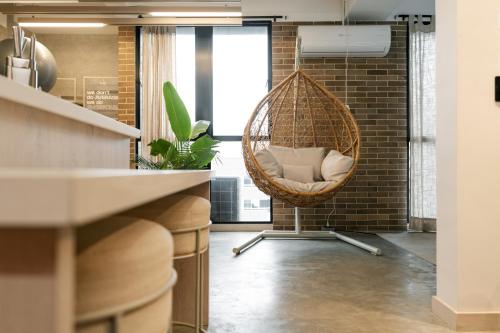a room with a hanging chair in a kitchen at Indie Universe Creative Hotel in Medellín