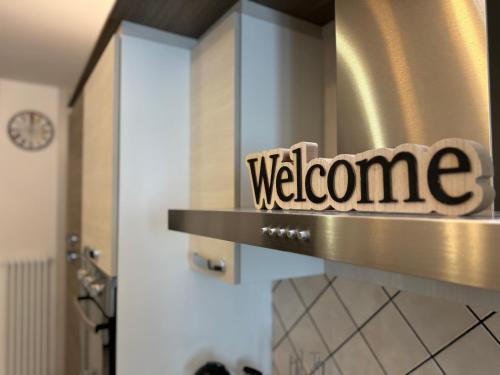 a welcome sign on a door in a room at Family Stylish Apartment in Norcia