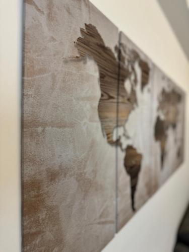 a map of the world on a wall at Family Stylish Apartment in Norcia