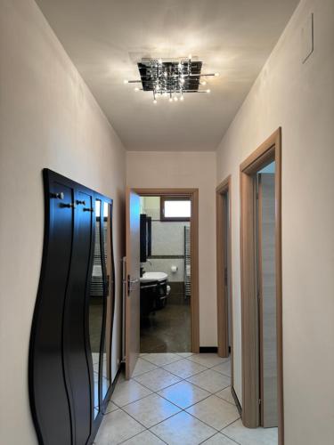 a room with a hallway with a door and a mirror at Family Stylish Apartment in Norcia